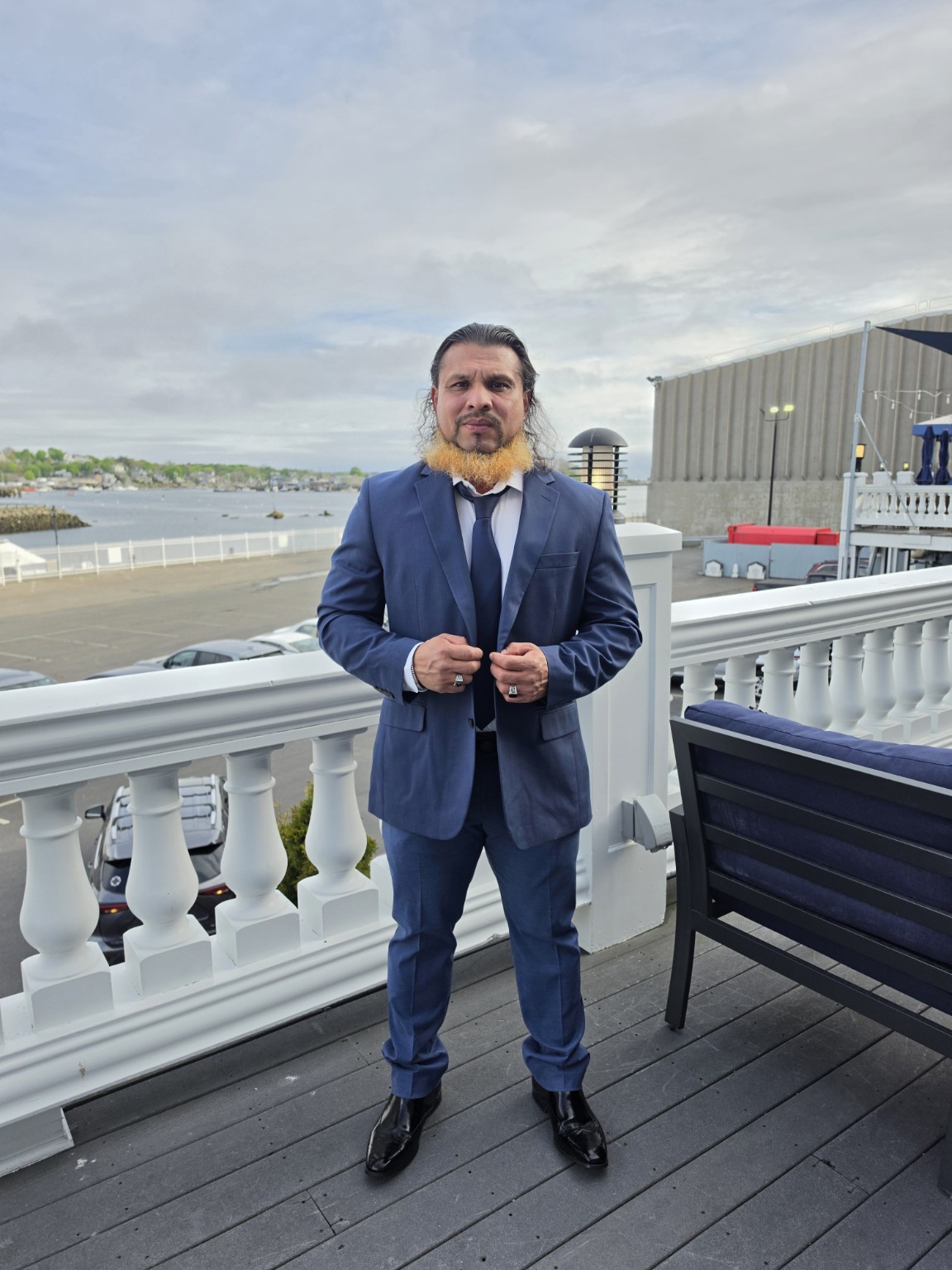 Coach Carlos Recinos wearing a blue suit